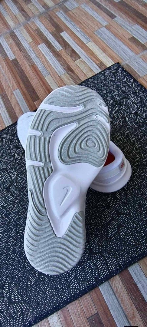 Nike White Running Shoes (Category: Sneakers) located in Manila. Submitted by ezekislacl02490 (Listing ID 1469068770, Image 2). Description: - Brand: Nike - Color: White with subtle grey swoosh and bright red insoles - Upper: Breathable mesh to keep feet cool - Sole: Chunky white foam for great cushioning and grip - Condition: Clean laces and neat stitching - Best for: Running, gym workouts, or casual walking.