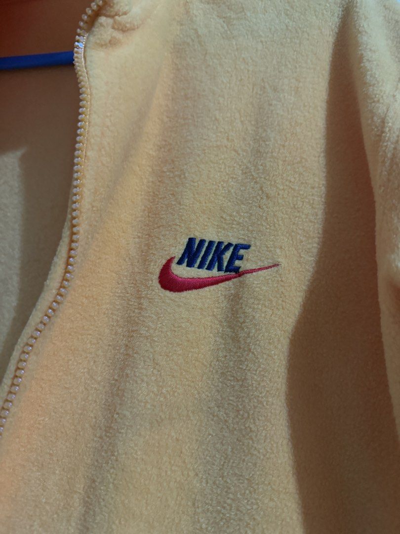 Nike Yellow Fleece Zip-Up Jacket (Category: Coats, Jackets and Outerwear) located in Paranaque City. Submitted by pausauz (Listing ID 1469040492, Image 2). Description: - Brand: Nike - Color: Bright yellow with embroidered blue and red logo - Material: Soft fuzzy fleece, great for cooler weather - Features: High collar, full front zip, and two side pockets - Fit: Relaxed fit with long sleeves, ideal for layering Fits S-M.
