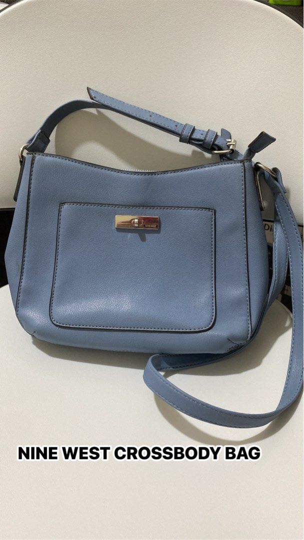 Nine West Crossbody Bag Blue (Category: Cross-body Bags) located in Silang. Submitted by princess_jasmin (Listing ID 1469105240, Image 1). Description: - Brand: Nine West - Color: Blue with stylish silver hardware - Closure: Secure zipper top main compartment + front pocket with turn-lock closure - Strap: Adjustable for shoulder or crossbody wear - Design: Clean, structured shape - Size: Ideal daily bag that easily fits your phone, wallet, and ke