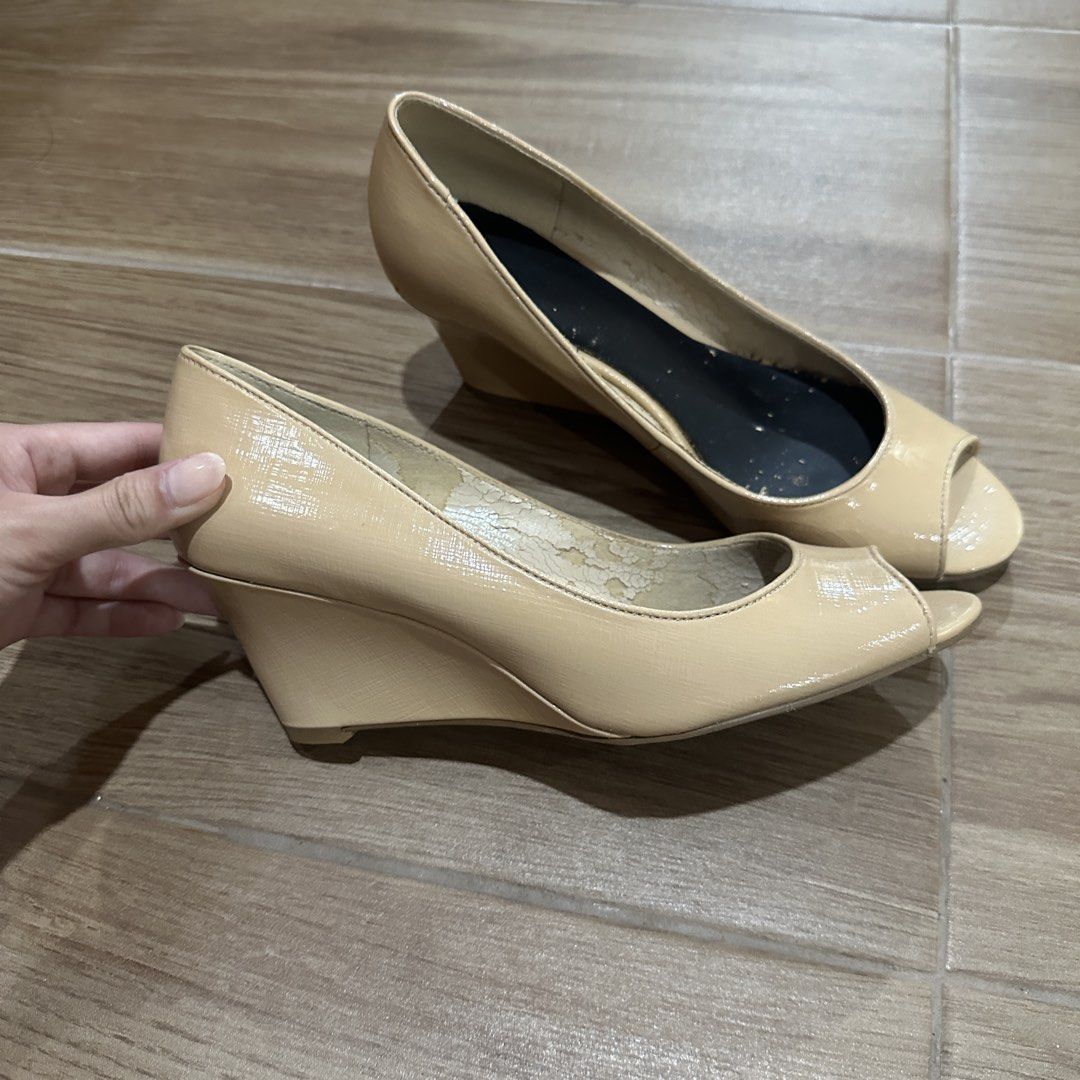 Nine West Nude Open Toe Wedge Heels (Category: Heels) located in Pasig City. Submitted by nina.declutter (Listing ID 1468991838, Image 1). Description: - Brand: Nine West - Style: Open toe slip-on wedge heels - Color: Classic nude patent - Size: 6.5M - Versatile neutral piece, great for workwear or casual outfits - Condition note: Heavy peeling and flaking on the interior lining, with minor wear on the soles.