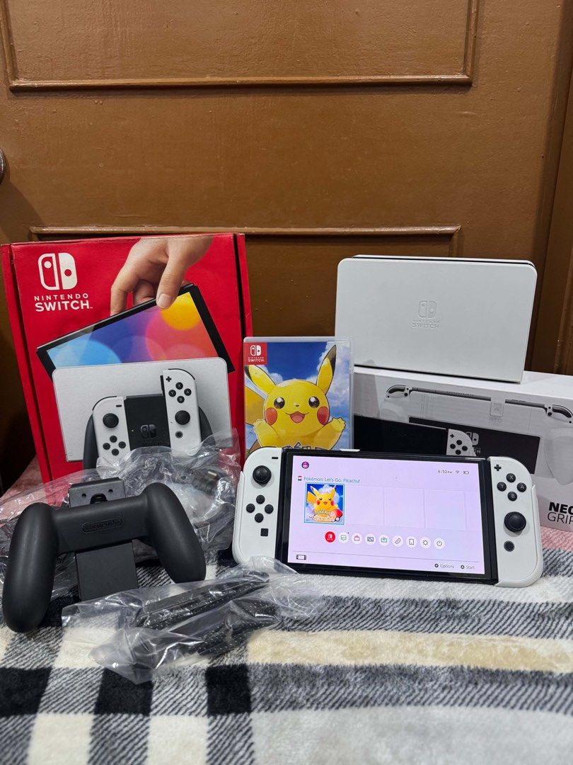 Nintendo Switch OLED Model White with Games and Accessories (Category: Nintendo) located in Manila. Submitted by billyngo0327158 (Listing ID 1469077039, Image 1). Description: - Nintendo Switch OLED Console (White) - 100% working condition - Complete with original box, dock, power cord, and HDMI cable - White Joy-Cons with straps and grip (neatly packed in plastic bags) - Includes physical Pokémon Let's Go Pikachu game cartridge - Comes with boxe