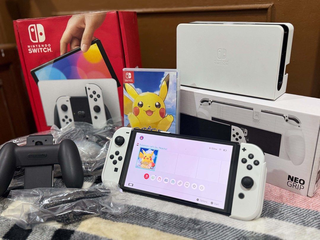 Nintendo Switch OLED Model White with Games and Accessories (Category: Nintendo) located in Manila. Submitted by billyngo0327158 (Listing ID 1469077039, Image 2). Description: - Nintendo Switch OLED Console (White) - 100% working condition - Complete with original box, dock, power cord, and HDMI cable - White Joy-Cons with straps and grip (neatly packed in plastic bags) - Includes physical Pokémon Let's Go Pikachu game cartridge - Comes with boxe