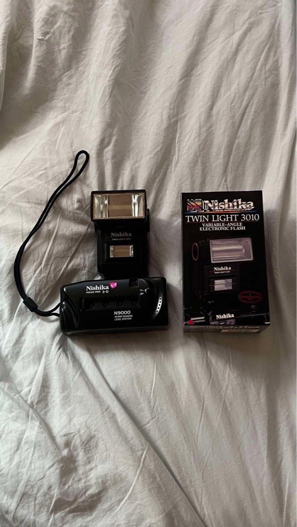 Nishika N9000 3D Camera with Twin Light 3010 Flash (Category: Cameras) located in Manila. Submitted by knowyourdosage (Listing ID 1468985289, Image 1). Description: - Complete Nishika N9000 35mm quadra lens 3D camera setup - Includes matching Nishika Twin Light 3010 variable-angle electronic flash in original retail box - Original hand strap attached to the camera body - Ideal bundle for retro 3D film photography enthusiasts - Tested and in great