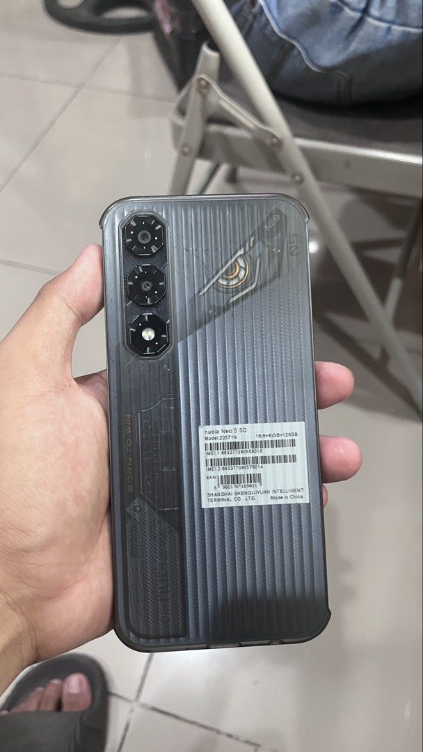 NUBIA NEO 5 5G (Category: Android Others) located in Manila. Submitted by eugenelau84148 (Listing ID 1469069648, Image 2). Description: - Brand: Nubia Model: Neo 5 5G - Storage & RAM: 128GB ROM, 16GB (8GB + 8GB) RAM - Design: Stylish grey textured back panel with mecha robot eye graphic and vertical triple camera setup - Condition: Excellent physical and working condition, clean screen - Meetup locations: SM Manila Food Court, Welcome Rotonda, or