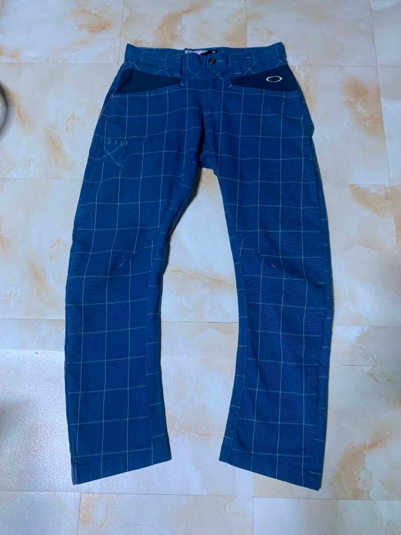 Oakley Blue Plaid Casual Pants Size 30 (Category: Trousers) located in Gingoog City. Submitted by talianjeri27046 (Listing ID 1469084515, Image 1). Description: - Brand: Oakley - Style: Blue checkered / plaid pants with contrast pocket panels - Size: 30 - Material: Cotton, polyester, and polyurethane blend - Origin: Made in Vietnam - Features: Embroidered Oakley logo near pocket and back, button closure, and belt loops - Condition: Clean, excelle