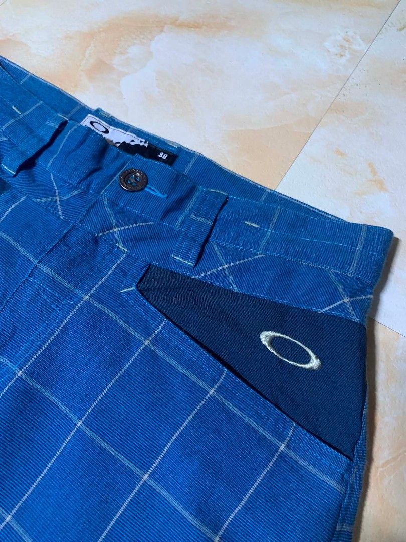 Oakley Blue Plaid Casual Pants Size 30 (Category: Trousers) located in Gingoog City. Submitted by talianjeri27046 (Listing ID 1469084515, Image 3). Description: - Brand: Oakley - Style: Blue checkered / plaid pants with contrast pocket panels - Size: 30 - Material: Cotton, polyester, and polyurethane blend - Origin: Made in Vietnam - Features: Embroidered Oakley logo near pocket and back, button closure, and belt loops - Condition: Clean, excelle