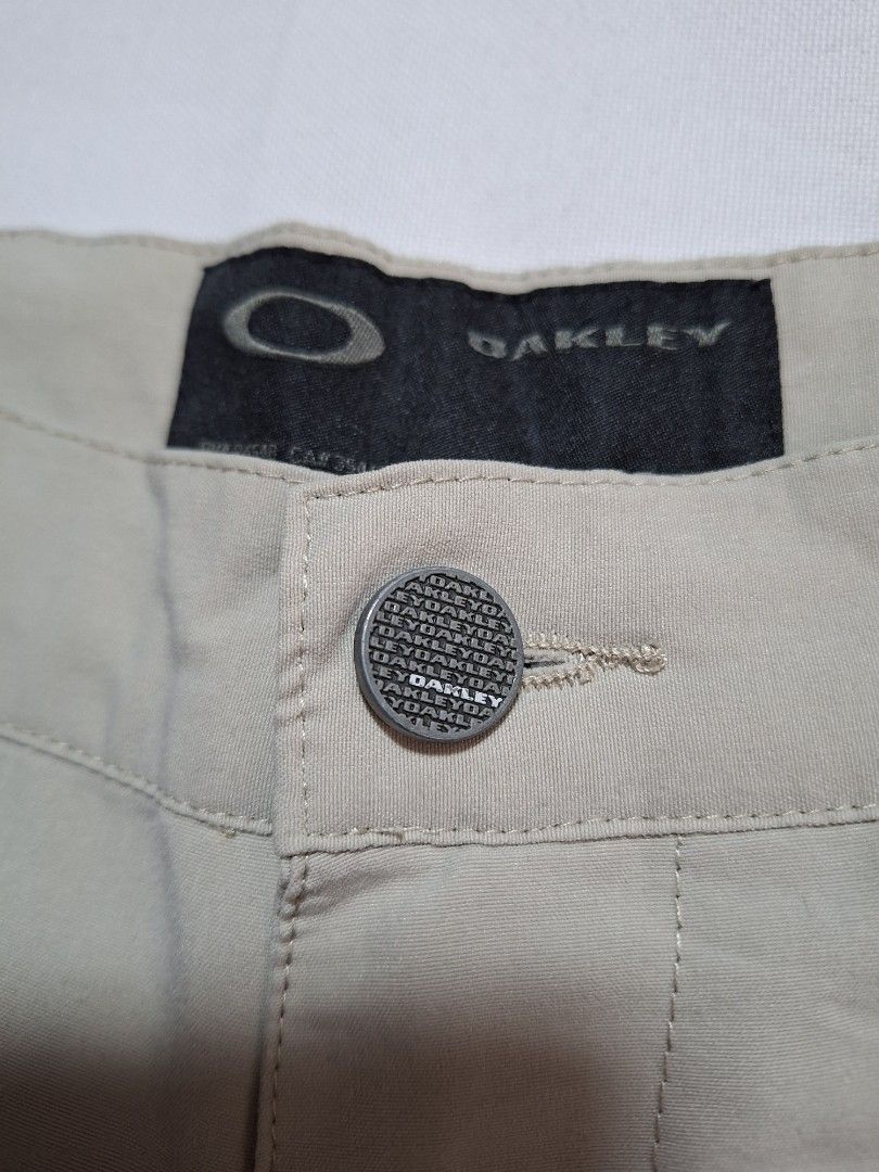 Oakley Tan Casual Pants Size 32W (Category: Chinos) located in Baguio. Submitted by restyrille77846 (Listing ID 1468980153, Image 2). Description: - Brand: Oakley - Style: Casual pants / trousers - Color: Beige / Tan - Size: 32W - Details: Branded button closure, embroidered Oakley ellipse logo near the pocket - Condition: Clean fabric, solid construction .