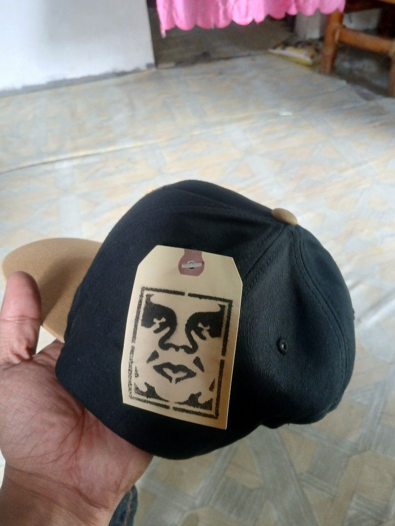 Obey Black Amber Gold Snapback Hat (Category: Caps & Hats) located in San Jose. Submitted by garments17 (Listing ID 1468961411, Image 3). Description: - Brand: Obey - Color: Black and Amber Gold - Condition: Brand new with original tags attached - Material: 100% cotton (Made in Bangladesh) - Size: One size fits all with adjustable snap closure - Details: Classic green under brim and round embroidered patch logo on the front crown.