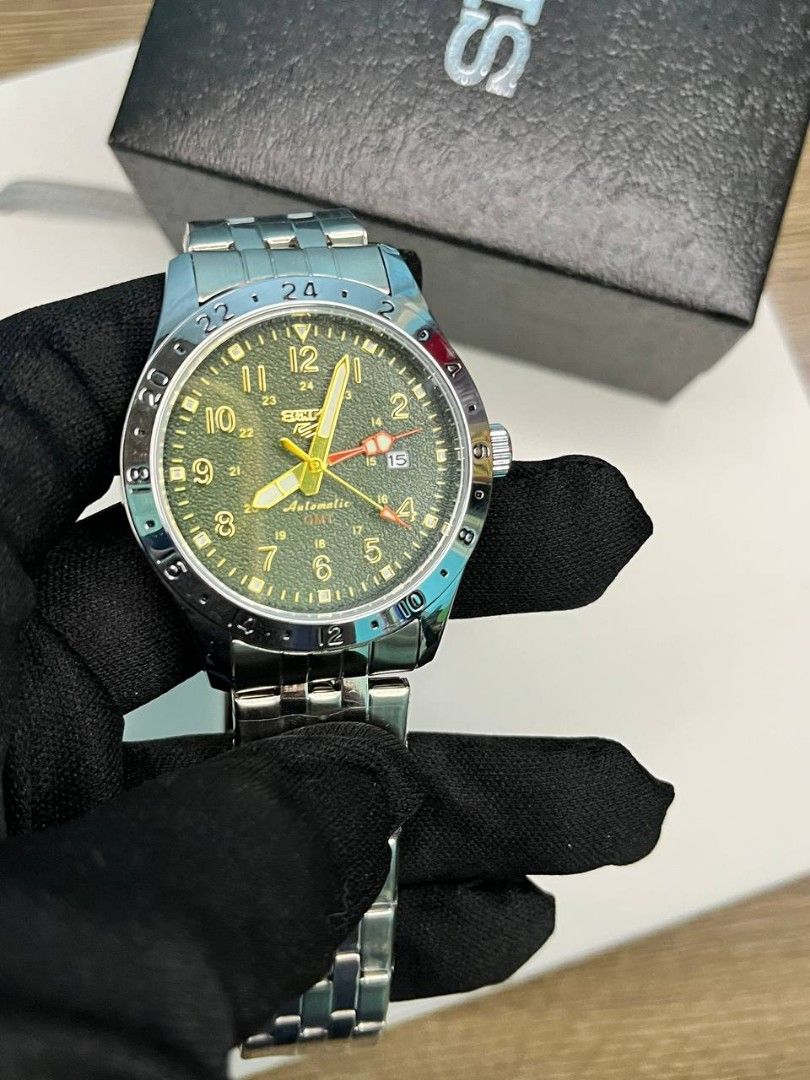 OEM WATCH ONLY‼️ (Category: Men's Watches) located in Manila. Submitted by seannathan46011 (Listing ID 1469070666, Image 1). Description: Selling an authentic Seiko 5 Sports Field GMT automatic watch featuring an olive green textured dial, bold Arabic numerals, and a vibrant yellow GMT hand. Encased in durable stainless steel with a matching multi-row bracelet and signed clasp. Comes with the original Seiko box. Perfect everyday automatic watch f