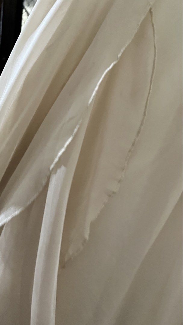Off-White Ruffled Maxi Dress Spaghetti Strap (Category: Dresses) located in Orion. Submitted by sofqzh (Listing ID 1468993895, Image 3). Description: - Color: Off-white - Style: Long dress with delicate spaghetti straps and layered ruffle skirt - Fit: Fitted bodice with a gathered waistline - Fabric: Lightweight, flowing material with a soft drape - Occasion: Ideal for evening events or warm weather outings - Condition: Excellent, with clean seam