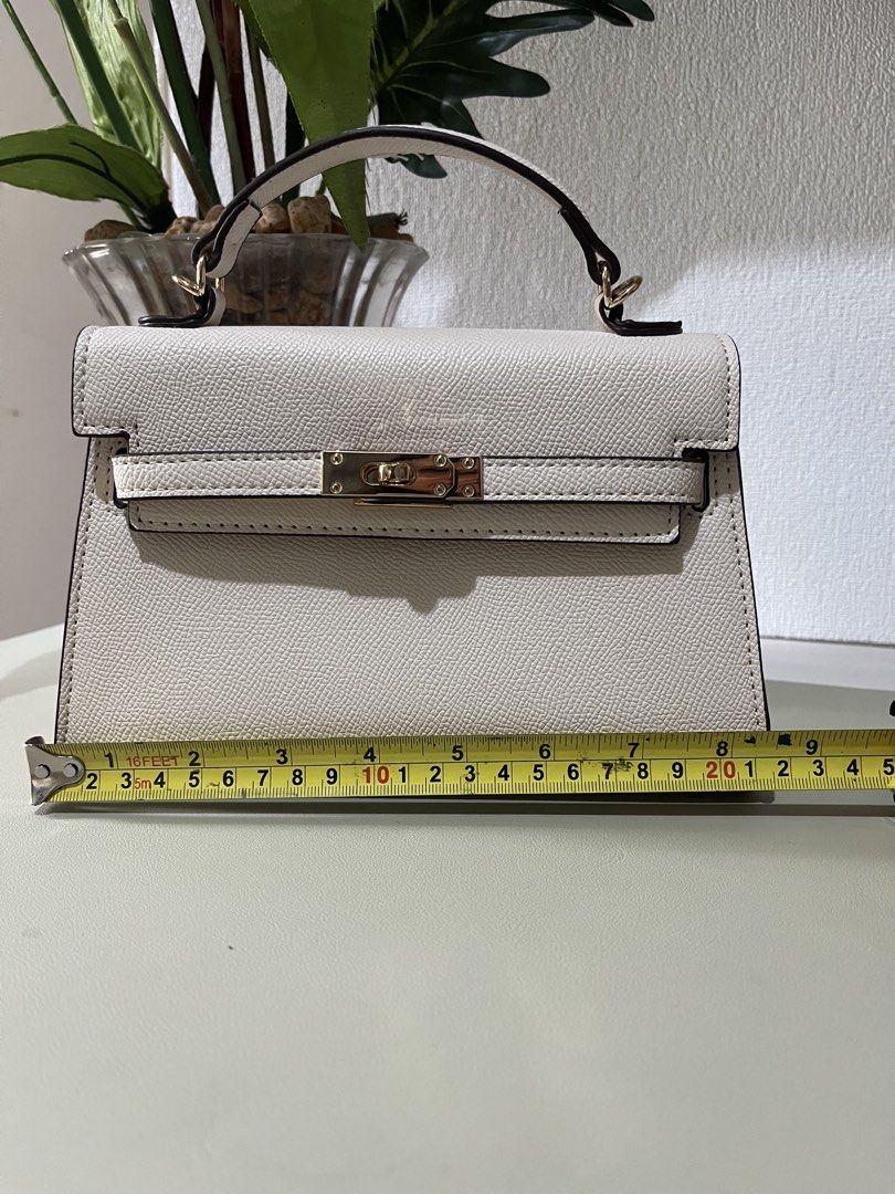 Off-White Structured Top Handle Bag with Gold Hardware (Category: Luxury Bags & Wallets) located in Quezon City. Submitted by eloveshopping.ph (Listing ID 1469046903, Image 3). Description: Off-white top handle bag with textured faux leather finish. Gold-tone hardware. Pristine condition, clean inside and out. Minor color transfer at the back (refer from last photo).