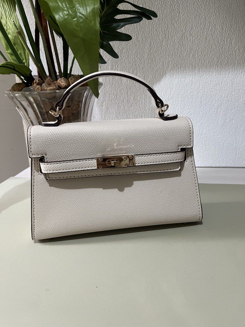 Off-White Structured Top Handle Bag with Gold Hardware (Category: Luxury Bags & Wallets) located in Quezon City. Submitted by eloveshopping.ph (Listing ID 1469046903, Image 1). Description: Off-white top handle bag with textured faux leather finish. Gold-tone hardware. Pristine condition, clean inside and out. Minor color transfer at the back (refer from last photo).