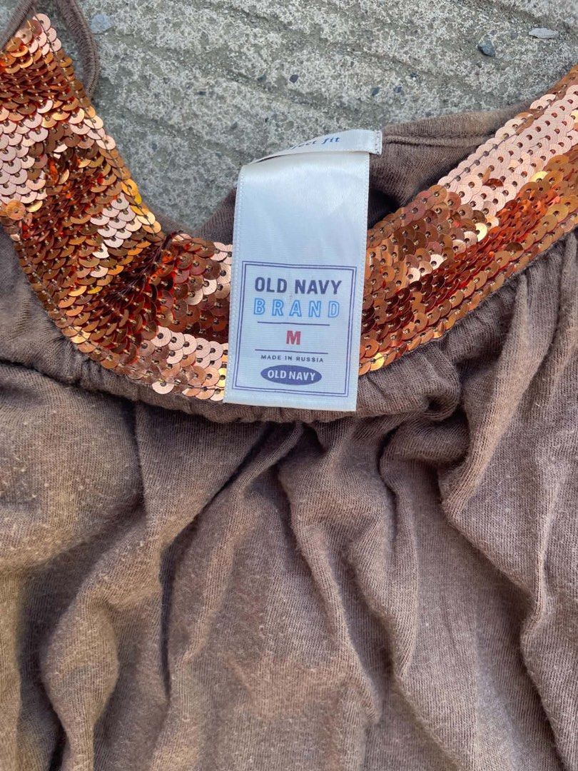 Old Navy Brown Tank Top with Sequins Medium (Category: Sleeveless) located in Manila. Submitted by declutterwithme07 (Listing ID 1469032014, Image 2). Description: - Brand: Old Navy - Color: Brown with shimmering copper sequin trim - Size: Medium - Straps: Thin spaghetti straps - Fit: Soft, relaxed, and flowy - Origin: Made in Russia - Condition: Excellent.