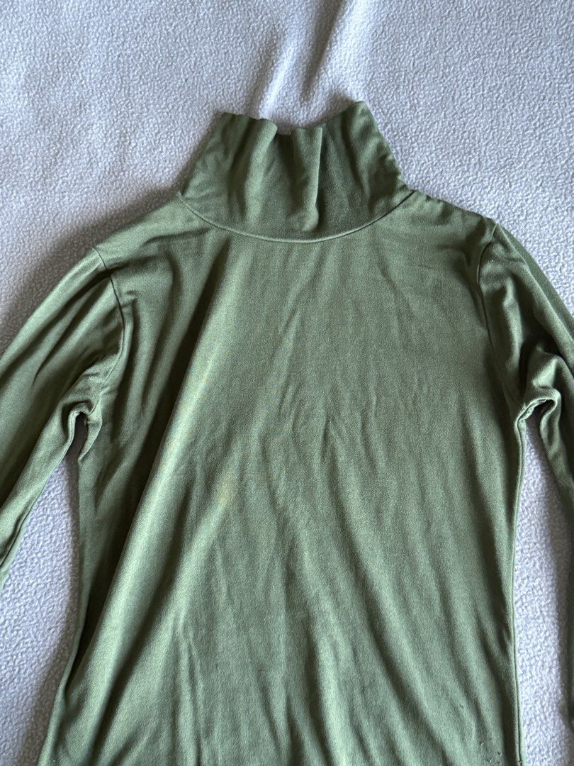 Olive green turtleneck long sleeve top (Category: Longsleeves) located in Pasig City. Submitted by laagn.ph (Listing ID 1469090374, Image 3). Description: - Color: Olive green - Style: Long sleeve with high turtleneck collar - Material: Soft, stretchable fabric for a comfortable fit - Versatile: Great basic piece for layering under sweaters and jackets - Condition: Good overall.