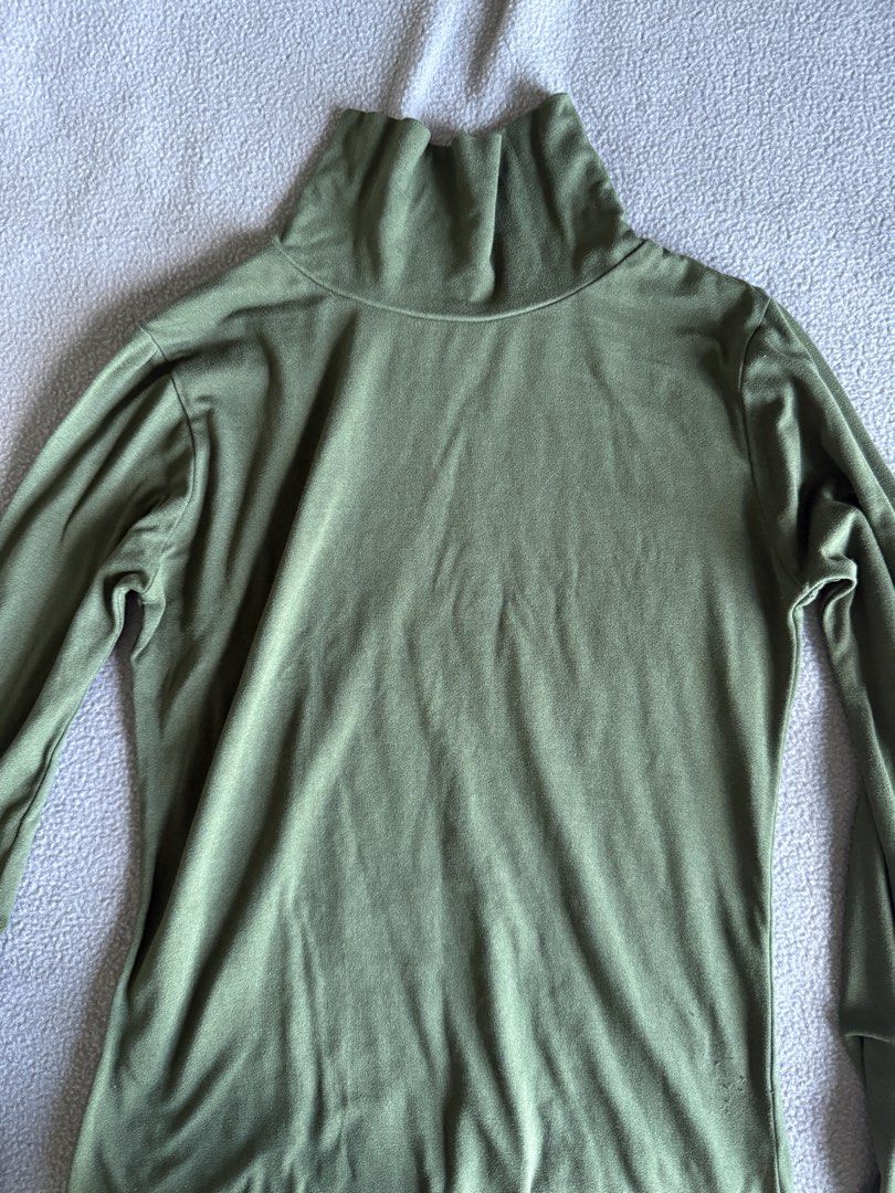 Olive green turtleneck long sleeve top (Category: Longsleeves) located in Pasig City. Submitted by laagn.ph (Listing ID 1469090374, Image 2). Description: - Color: Olive green - Style: Long sleeve with high turtleneck collar - Material: Soft, stretchable fabric for a comfortable fit - Versatile: Great basic piece for layering under sweaters and jackets - Condition: Good overall.