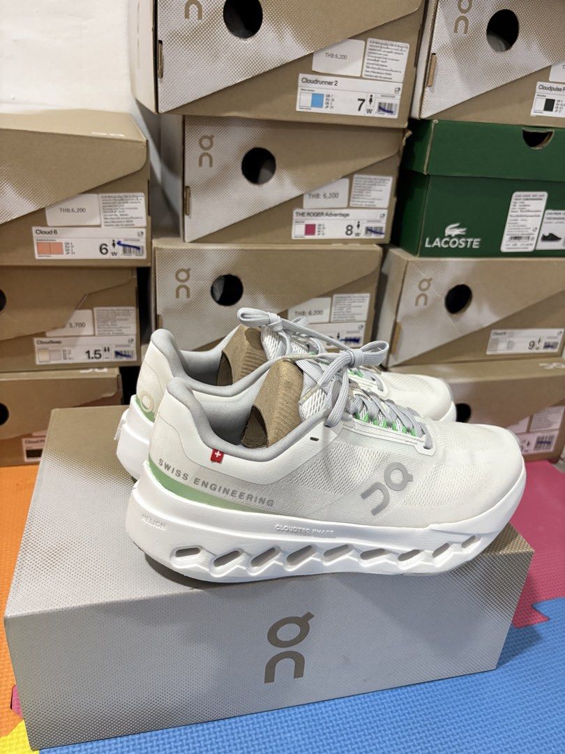 On Cloudsurfer Next White Silver Running Shoes (Category: Sneakers) located in Manila. Submitted by pikkathchu (Listing ID 1469072470, Image 2). Description: - Color: White and silver with light green eyelet details and heel accent - Technology: Cloudtec Phase sole setup for ultimate comfort - Branding: Swiss engineering details on the side - Closure: Lace-up with flat laces - Inclusions: Original On shoebox included - Condition: Brand new/Mint (