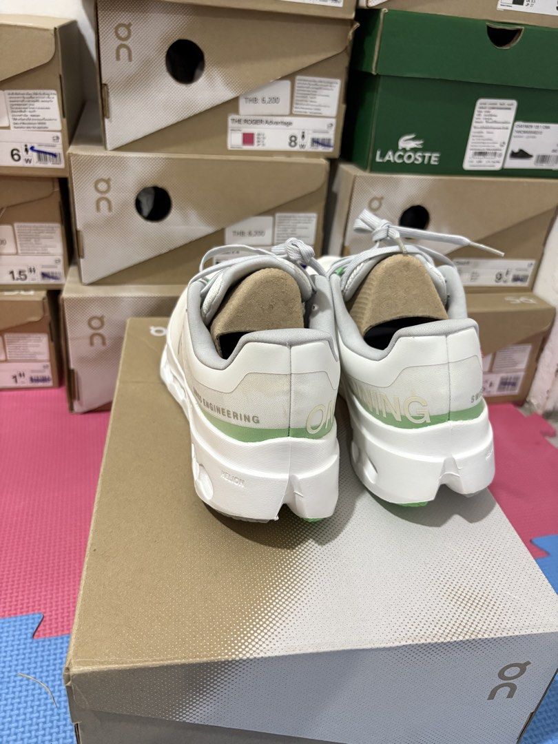 On Cloudsurfer Next White Silver Running Shoes (Category: Sneakers) located in Manila. Submitted by pikkathchu (Listing ID 1469072470, Image 3). Description: - Color: White and silver with light green eyelet details and heel accent - Technology: Cloudtec Phase sole setup for ultimate comfort - Branding: Swiss engineering details on the side - Closure: Lace-up with flat laces - Inclusions: Original On shoebox included - Condition: Brand new/Mint (