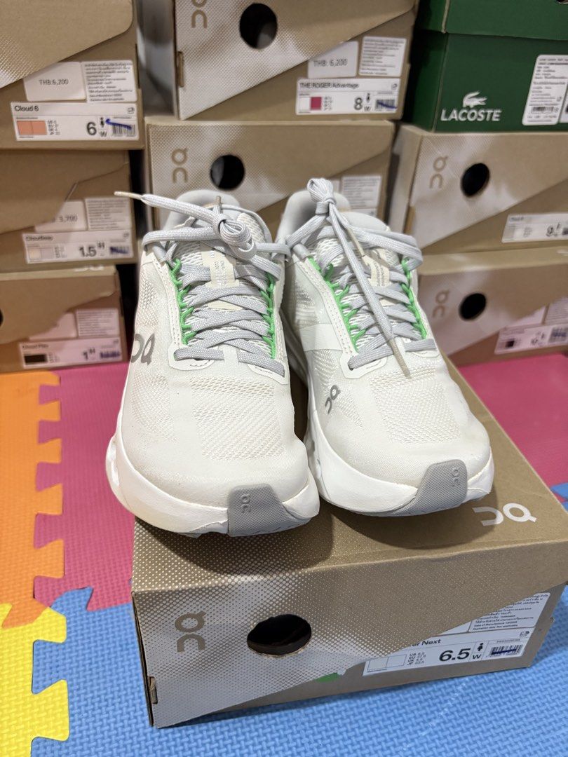 On Cloudsurfer Next White Silver Running Shoes (Category: Sneakers) located in Manila. Submitted by pikkathchu (Listing ID 1469072470, Image 1). Description: - Color: White and silver with light green eyelet details and heel accent - Technology: Cloudtec Phase sole setup for ultimate comfort - Branding: Swiss engineering details on the side - Closure: Lace-up with flat laces - Inclusions: Original On shoebox included - Condition: Brand new/Mint (
