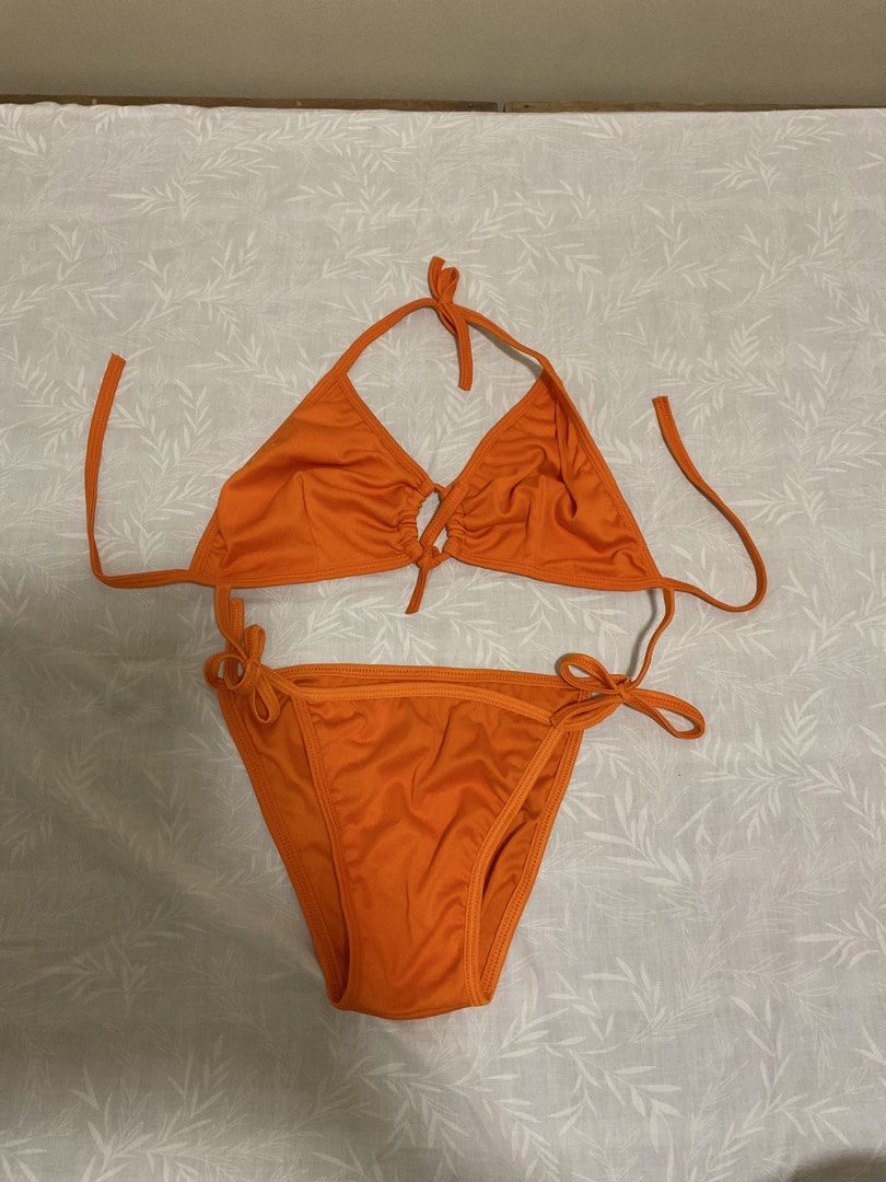 Orange Two-Piece Halter Bikini Swimsuit (Category: Bikinis & Swimsuits) located in Taytay. Submitted by prelovedbyblaire (Listing ID 1469102372, Image 1). Description: - Color: Vibrant Orange - Style: Two-piece bikini set - Top: Halter neck with adjustable triangle cups and center gathering - Bottoms: Adjustable side ties for a custom fit - Material: Lightweight, quick-dry swimwear fabric - Ideal for: Beach trips, pool days, and upcoming vacation