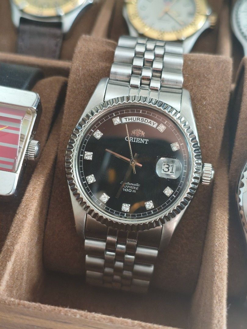 Orient Day Date President (Category: Men's Watches) located in Manila. Submitted by brick.owens (Listing ID 1469063567, Image 1). Description: silver in black dial 36mm ultra rare and discontinued model sapphire crystal with date magnifier fluted bezel jubilee bracelet untouched / unpolished naked.