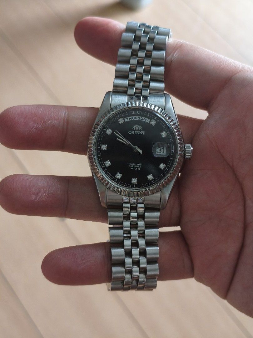 Orient Day Date President (Category: Men's Watches) located in Manila. Submitted by brick.owens (Listing ID 1469063567, Image 2). Description: silver in black dial 36mm ultra rare and discontinued model sapphire crystal with date magnifier fluted bezel jubilee bracelet untouched / unpolished naked.