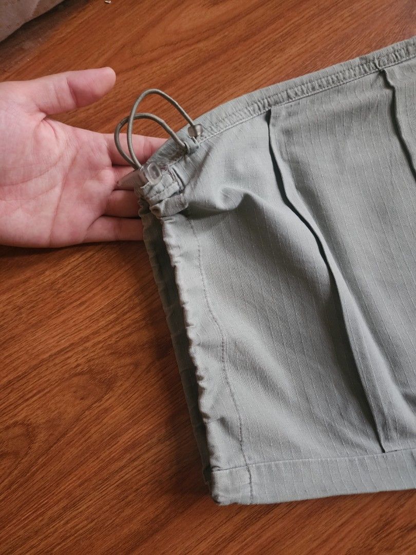 Outdoors Sage Green Cargo Shorts with Drawstring Cuffs (Category: Shorts) located in Pasig City. Submitted by mhiroel (Listing ID 1468963834, Image 3). Description: - Color: Trendy sage green - Fabric: Textured pattern throughout for extra style - Closure: Secure zipper fly with button - Pockets: Handy side and back pockets - Fit: Adjustable drawstring hems for a custom fit - Ideal for: Casual everyday wear, weekends, and outdoor activities.