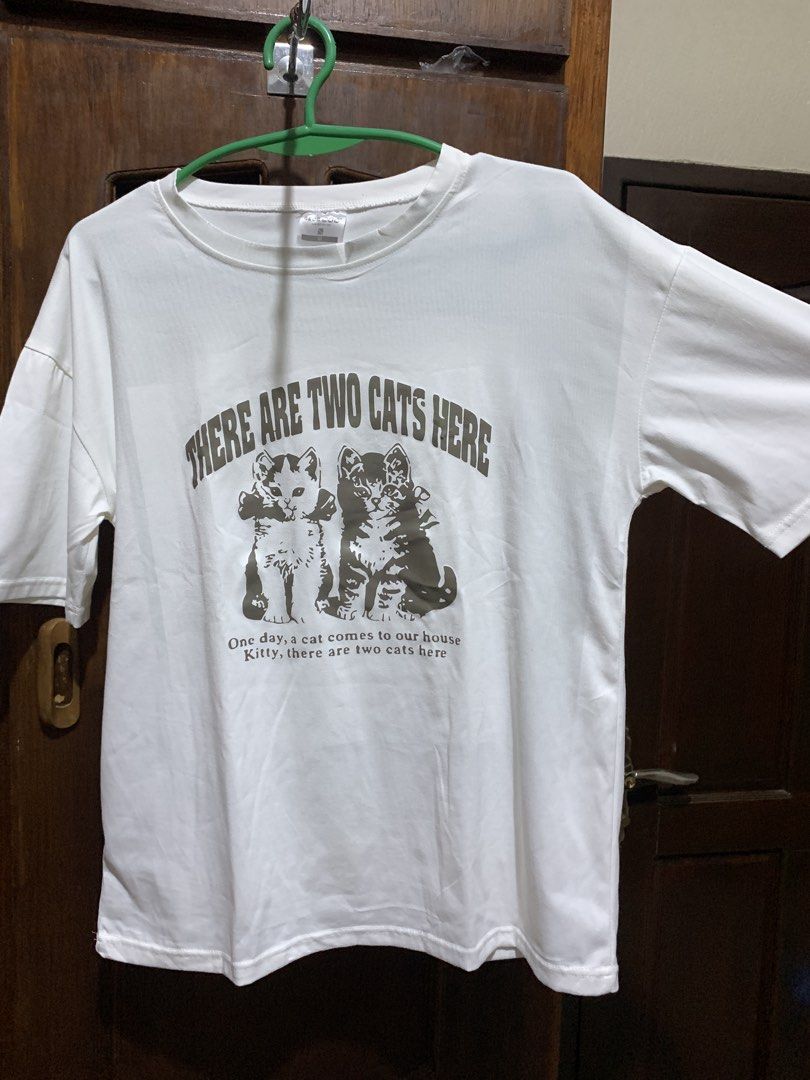 Oversized White Cat Print Shirt - Medium Georman (Category: Shirts) located in Angeles City. Submitted by c.alison (Listing ID 1469095315, Image 1). Description: Never used RFS: Moving out, downsizing my closet 📣 All of my listings will be taken down in February 2027 because I’m moving^^ Feel free to DM me if you have any questions! Shipping via J&T, Grab, or LBC - COD available with LBC Meet up available outside DLSU Taft or SM Clark Payment vi