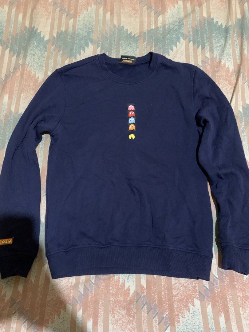 Pac-Man Dark Blue Crewneck Sweatshirt (Category: Coats, Jackets and Outerwear) located in Manila. Submitted by trickfinds (Listing ID 1468971964, Image 1). Description: - Color: Dark blue - Design: Stacked Pac-Man graphic on chest and small embroidered detail near right cuff - Material: Comfortable fleece lining inside - Features: Classic ribbed cuffs and hem - Style: Retro arcade gaming vibe - Condition: Brand new / Excellent quality - Mode of P