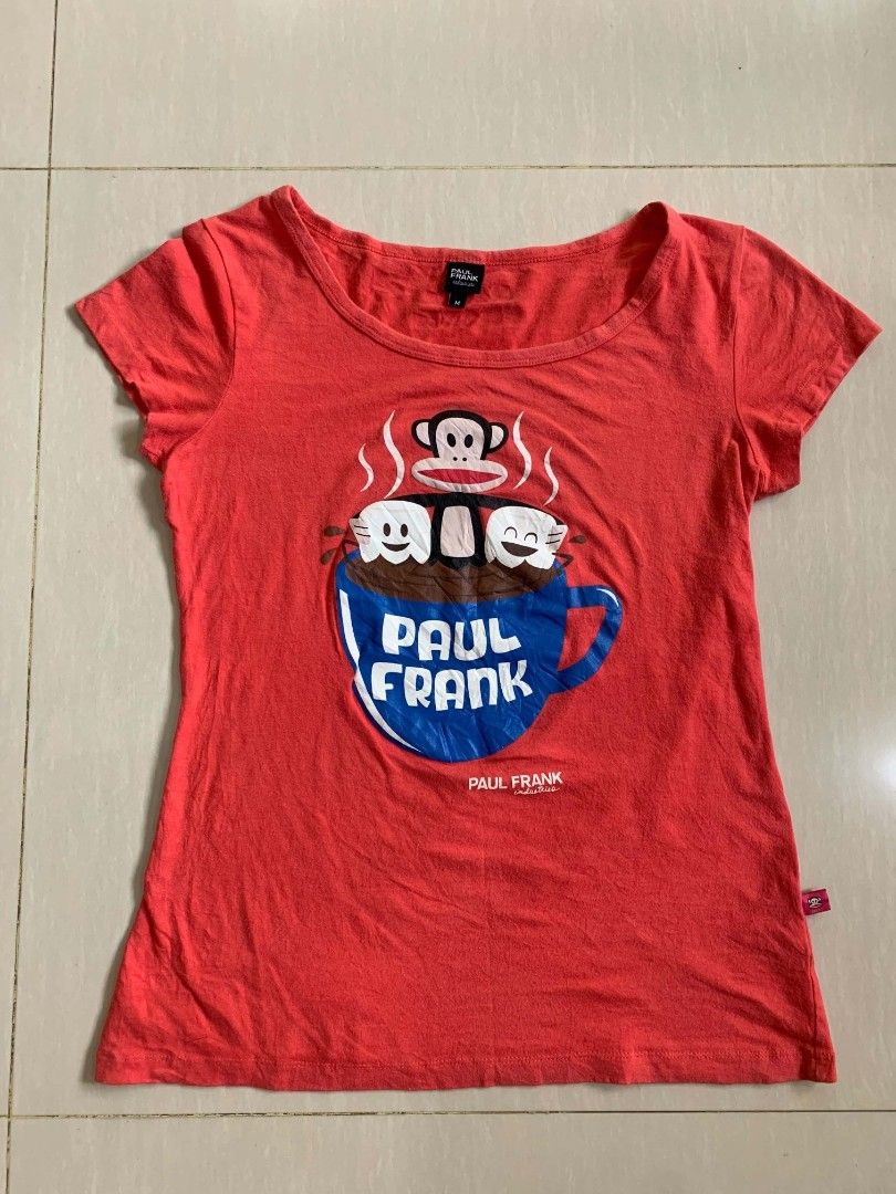 Paul Frank Red Graphic Tee Size M (Category: Shirts) located in Tiaong. Submitted by cdoswan (Listing ID 1468964401, Image 1). Description: - Brand: Paul Frank - Color: Bright red with fun coffee mug & monkey graphic - Size: Medium (tag attached) S-M - Fit & Style: Scoop neckline, short sleeves, super comfortable casual everyday top - Details: Small branded red tag on lower left hemline - Condition: Light fading from normal wash and wear.
