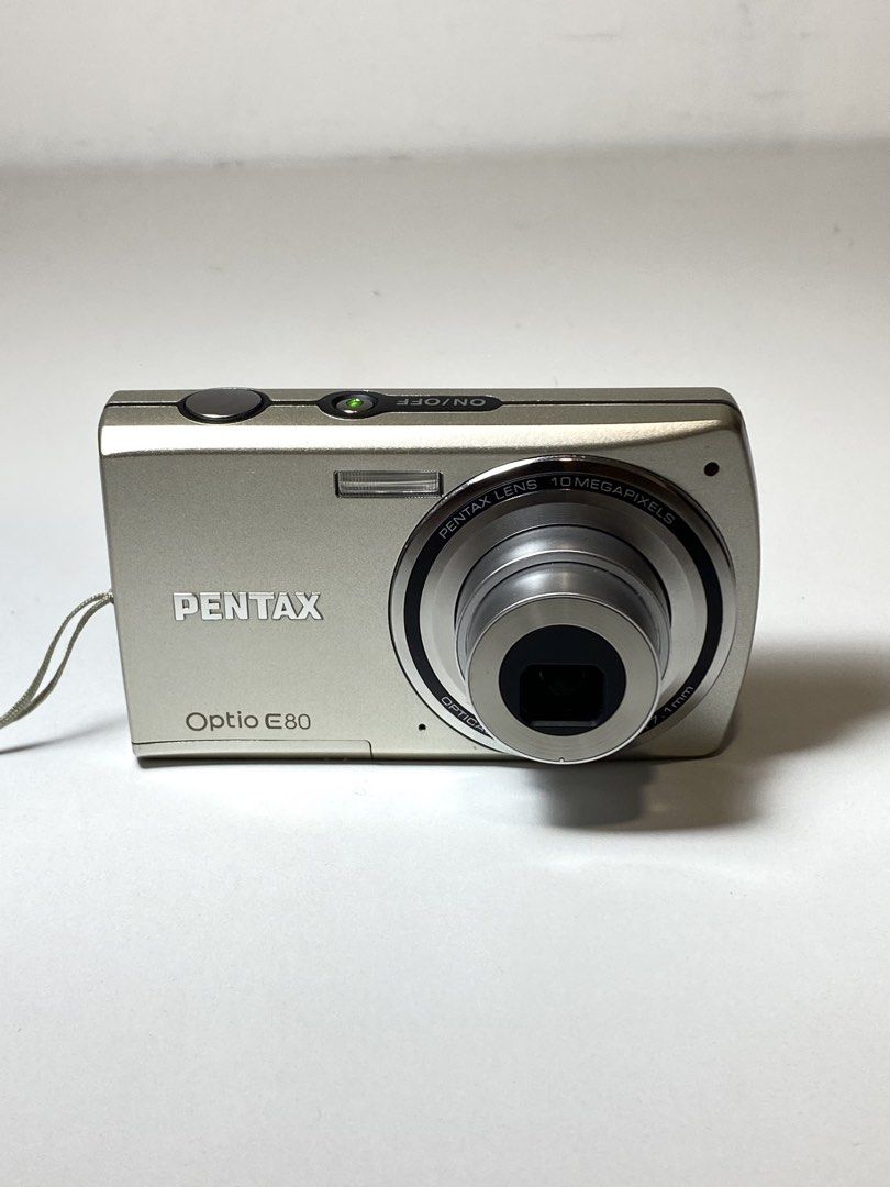 Pentax Opto E80 Digital Camera with Box and Accessories (Category: Cameras) located in Quezon City. Submitted by helloclassiques (Listing ID 1469024953, Image 3). Description: All buttons, zoom feature, and flash are working. 👾🌟 Specs: 10 MP CCD sensor (film-like output) 6 MB built in memory 3x Optical zoom 2.17” LCD Powered by (2) AA batteries SD/SDHC memory card slot w/ English language Inclusions: Original box x2 Fujitsu batteries USB AA cha