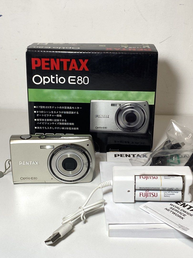 Pentax Opto E80 Digital Camera with Box and Accessories (Category: Cameras) located in Quezon City. Submitted by helloclassiques (Listing ID 1469024953, Image 1). Description: All buttons, zoom feature, and flash are working. 👾🌟 Specs: 10 MP CCD sensor (film-like output) 6 MB built in memory 3x Optical zoom 2.17” LCD Powered by (2) AA batteries SD/SDHC memory card slot w/ English language Inclusions: Original box x2 Fujitsu batteries USB AA cha
