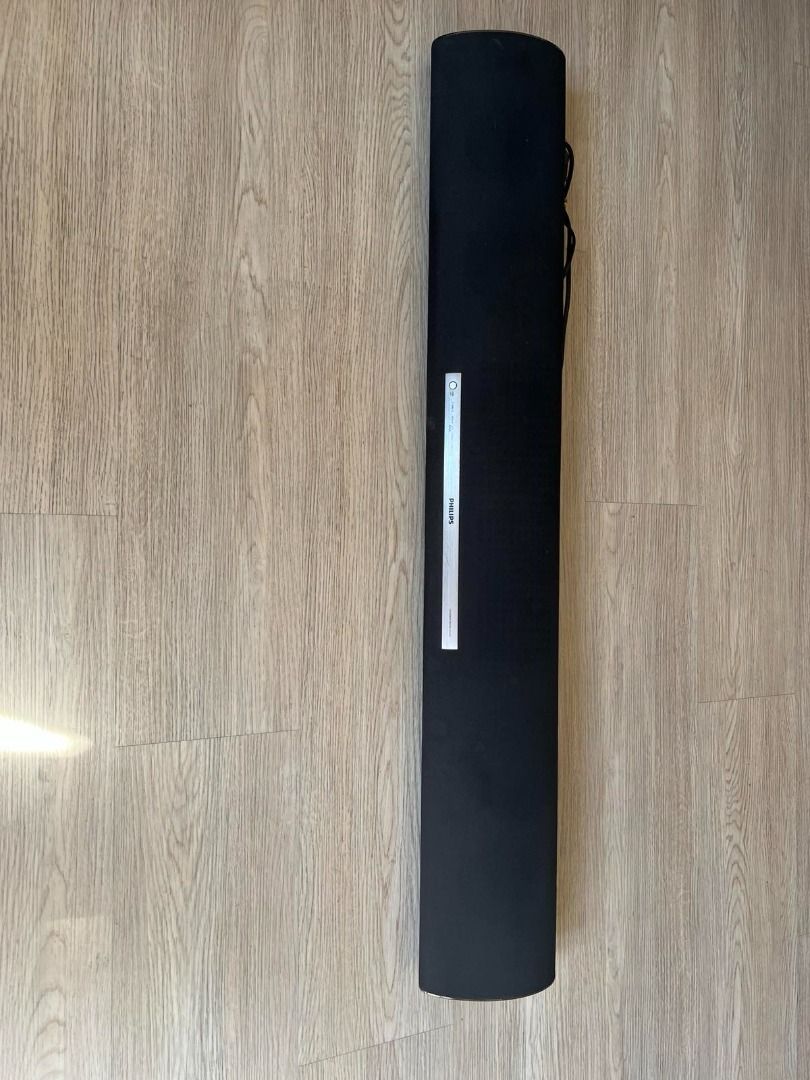 Philips Soundbar Speaker Black (Category: Soundbars, Speakers & Amplifiers) located in Manila. Submitted by pengsalvador (Listing ID 1468936005, Image 1). Description: - Brand: Philips - Type: Black soundbar speaker with fabric mesh cover - Design: Long rectangular unit with a silver control panel and brand logo near the center - Condition: Clean body, minimal exterior wear, well-maintained - Features: Built-in control buttons, attached power cor