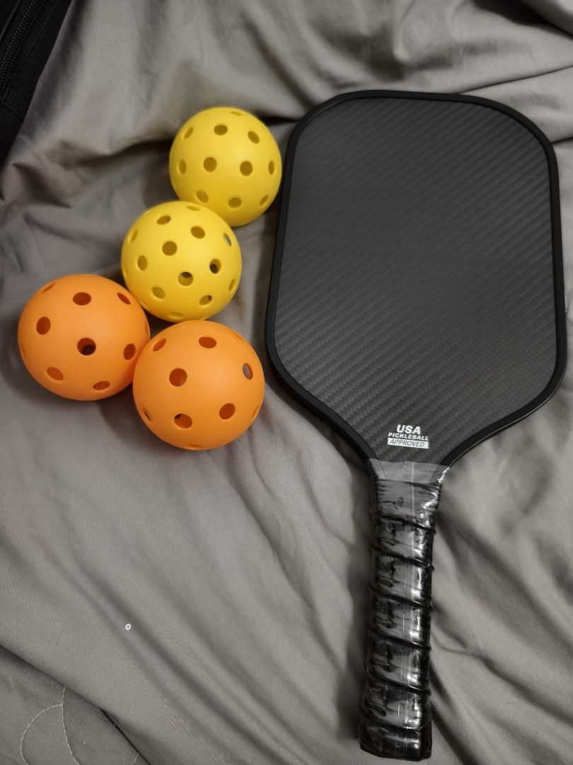 Pickleball Paddle Set with Balls and Carry Bag (Category: Racket and Ball Sports) located in Angeles City. Submitted by measaliman02351 (Listing ID 1469109491, Image 2). Description: - Complete pickleball set ready for the courts - Premium carbon fiber paddle with USA Pickleball approved stamp - Includes 4 balls in high-visibility yellow and orange - Comes with a sleek black carry bag for easy transport.