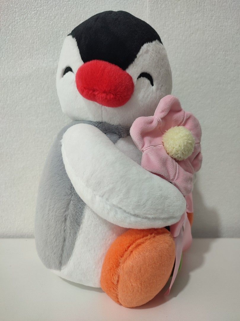 Pingu plush toy holding pink flower (Category: Plushies & Soft Toys) located in Manila. Submitted by epicmountain-f20453 (Listing ID 1468983619, Image 1). Description: - Adorable official Pingu plush toy holding a pink flower with a green stem and pink ribbon - Classic color scheme: white, black, grey, and orange - Comes with original Pingu branding tag - Stored properly in a clean, smoke-free space - Perfect for gifts, collectors, or Pingu fans!