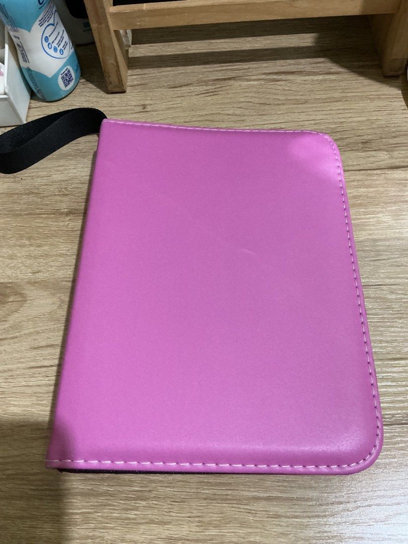 Pink 3-Ring Binder Photocard Holder (Category: Trading Cards Accessories) located in Manila. Submitted by jnnnnnnnjnn (Listing ID 1468986340, Image 1). Description: - Color: Pink with black wrist strap - Closure: Secure zipper - Ring Type: 3-metal ring mechanism - Capacity: Includes double-sided clear 4-pocket pages - Protection: Soft fabric inner lining keeps photocards, polaroids, and trading cards safe and scratch-free - Perfect for K-pop coll