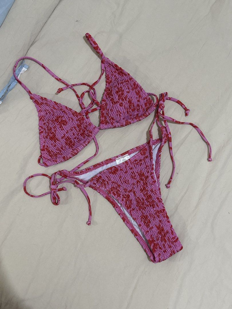 Pink and Red Smocked String Bikini Set (Category: Bikinis & Swimsuits) located in Quezon City. Submitted by tin.008 (Listing ID 1469031972, Image 1). Description: - Design: Pink and red floral pattern with trendy smocked textured fabric - Top: Triangle bikini style with adjustable halter ties for a custom fit - Bottoms: Matching string bikini with adjustable side ties - Fit: Stretchy, comfortable material ideal for beach days and pool hangs - Con