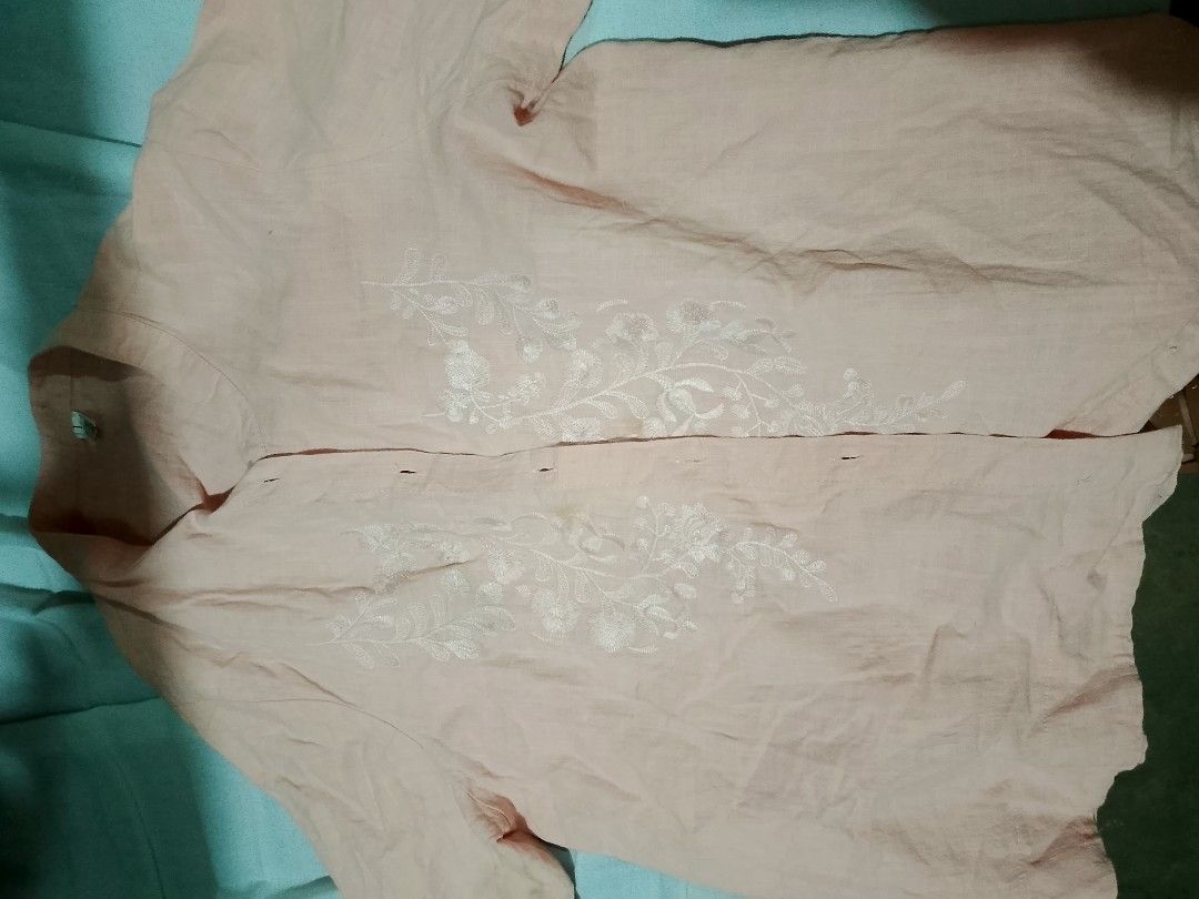 Light Orange Button Down Blouse with White Floral Embroidery (Category: Blouses) located in Batangas. Submitted by sheenx.09 (Listing ID 1468978921, Image 2). Description: - Color: light orange - Style: Short sleeve button-down blouse with mandarin collar 🫶 - Design: Detailed white floral embroidery on front panels 😃 - Fit: Relaxed and comfortable - Material: Lightweight fabric 😊 - Condition: Brand new/Excellent (Ready to wear).