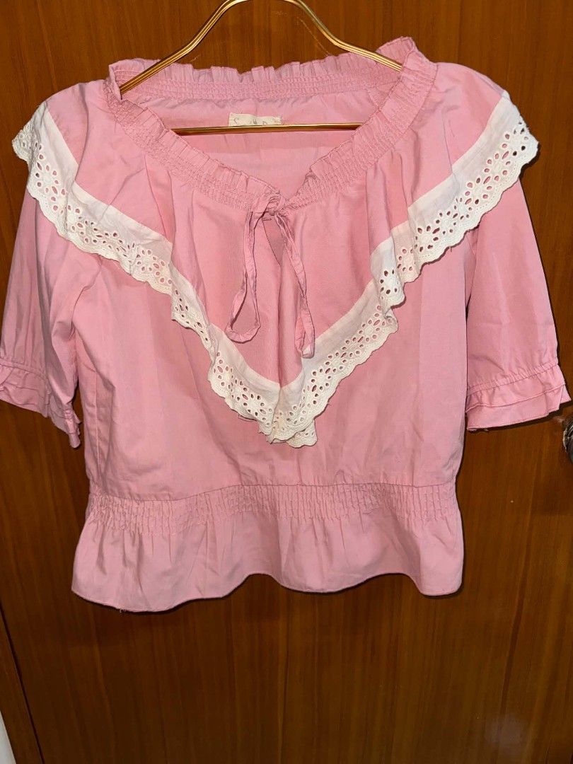 Pink Eyelet Ruffle Off Shoulder Blouse (Category: Blouses) located in Caloocan City. Submitted by mylove326 (Listing ID 1469031264, Image 2). Description: Pink cotton blouse with a big white eyelet lace collar. Half sleeves with ruffled cuffs. Smocked elastic waist and neckline with a drawstring tie. Measurements check photos probably for Small-medium .
