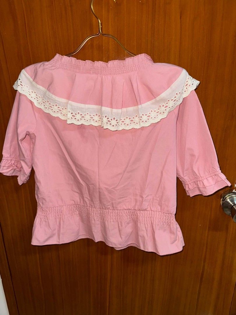 Pink Eyelet Ruffle Off Shoulder Blouse (Category: Blouses) located in Caloocan City. Submitted by mylove326 (Listing ID 1469031264, Image 3). Description: Pink cotton blouse with a big white eyelet lace collar. Half sleeves with ruffled cuffs. Smocked elastic waist and neckline with a drawstring tie. Measurements check photos probably for Small-medium .
