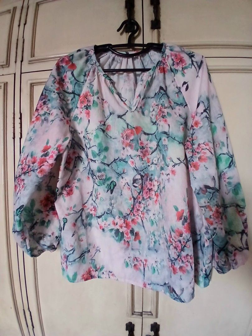 Cherry Blossom V-Neck Blouse with Long Sleeves (Category: Blouses) located in Manila. Submitted by f.s_prelov3d (Listing ID 1468987876, Image 2). Description: - Pink blouse with red floral and branch print - V-neckline with a trendy split front - Long balloon sleeves with gathered wrists - cotton Lightweight, easy-to-tuck fabric - Perfect for casual everyday wear.