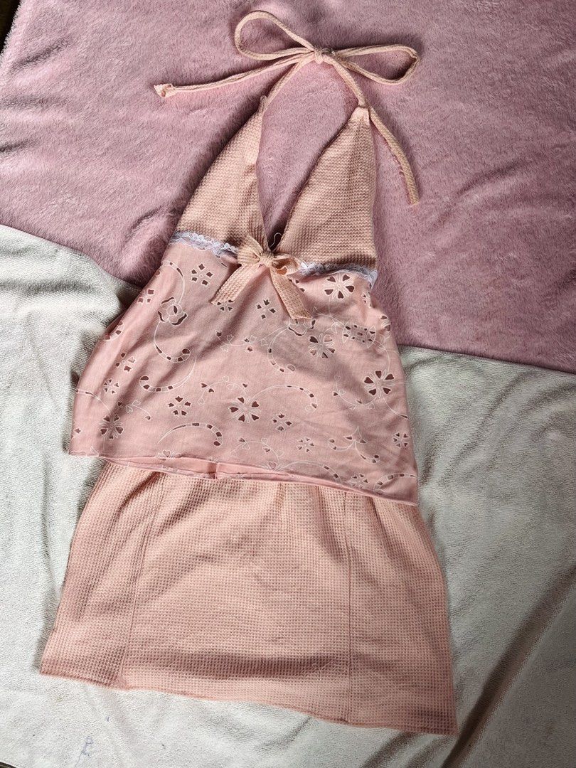 Pink halter top and mini skirt set (Category: Sets or Coordinates) located in Valenzuela. Submitted by closettee_ (Listing ID 1468953960, Image 1). Description: - Style: Matching pink two-piece set with a halter top and mini skirt - Top Details: Adjustable tie straps, small front bow, white lace trim, and sheer floral overlay - Fabric: Soft pastel pink waffle-knit textured material - Ideal For: Warm weather, dates, or casual outings - Condition: 
