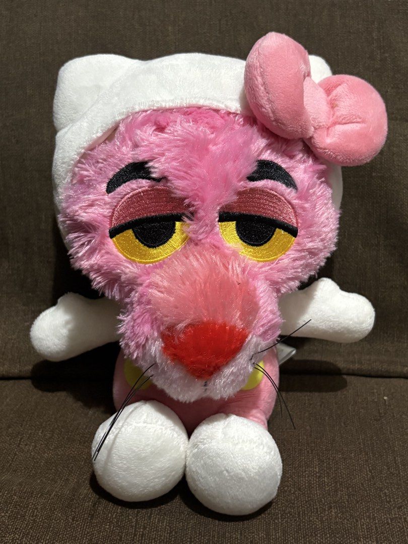 Pink Panther Hello Kitty Crossover Plush Toy (Category: Plushies & Soft Toys) located in Taguig. Submitted by goofysofties (Listing ID 1468971348, Image 1). Description: Pink Panther dressed up in a Hello Kitty costume. Wears the iconic white hood, pink bow, and pink overalls. Soft plush material all over with embroidered facial features. Fluffy tail attached at the back. Clean and ready for a new home..