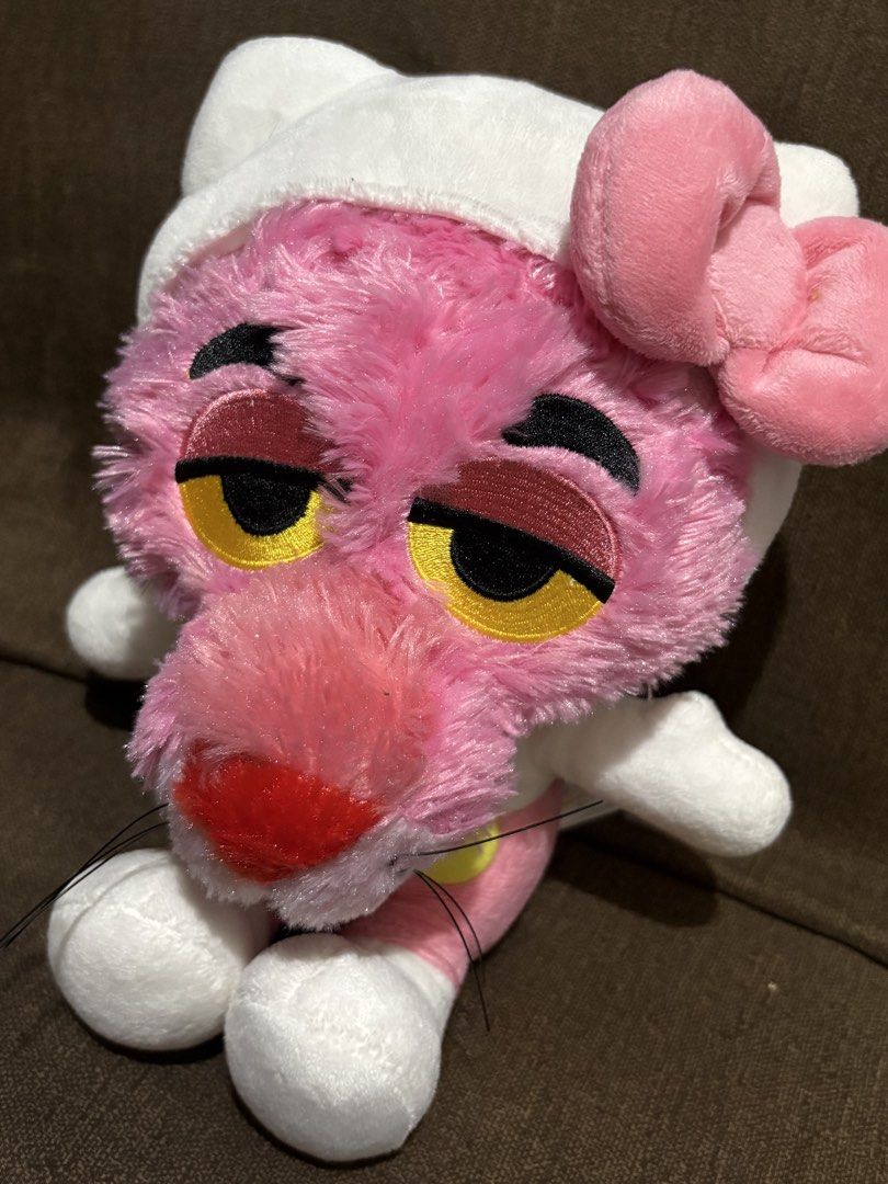 Pink Panther Hello Kitty Crossover Plush Toy (Category: Plushies & Soft Toys) located in Taguig. Submitted by goofysofties (Listing ID 1468971348, Image 3). Description: Pink Panther dressed up in a Hello Kitty costume. Wears the iconic white hood, pink bow, and pink overalls. Soft plush material all over with embroidered facial features. Fluffy tail attached at the back. Clean and ready for a new home..
