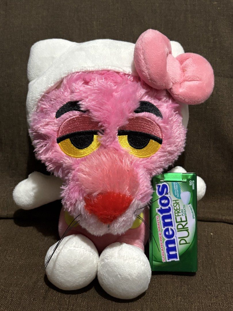 Pink Panther Hello Kitty Crossover Plush Toy (Category: Plushies & Soft Toys) located in Taguig. Submitted by goofysofties (Listing ID 1468971348, Image 2). Description: Pink Panther dressed up in a Hello Kitty costume. Wears the iconic white hood, pink bow, and pink overalls. Soft plush material all over with embroidered facial features. Fluffy tail attached at the back. Clean and ready for a new home..
