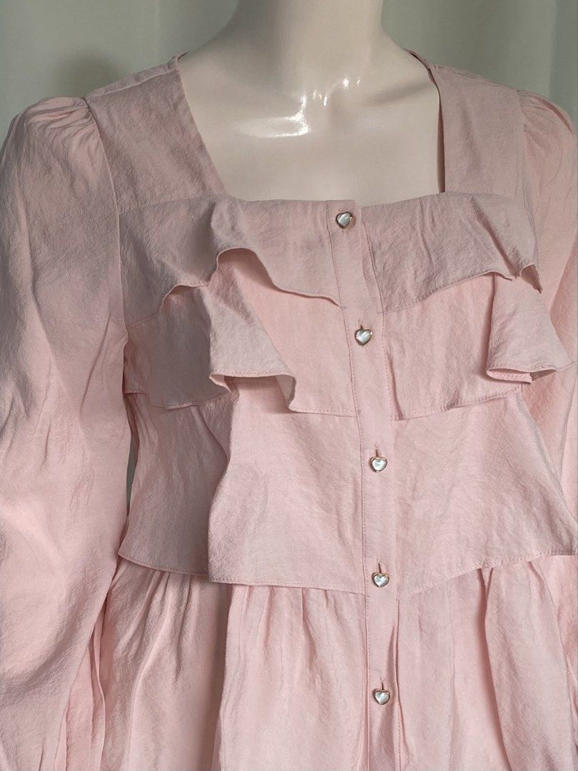 Pink Ruffle Square Neck Blouse Medium (Category: Blouses) located in Batangas. Submitted by mynne_09 (Listing ID 1469005066, Image 3). Description: - Color: Pink - Size: Medium - Neckline: Square neck - Details: Layered front ruffles, flared cuffs, and sweet heart-shaped buttons - Closure: Button-down front - Style: Super cute, pairs great with skirts - Condition: Excellent.
