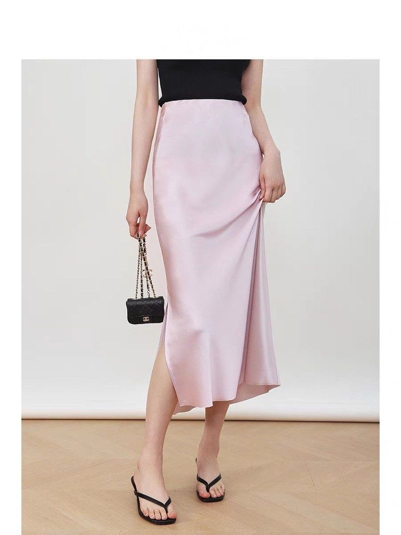 Pink Satin Midi Skirt with Side Slit (Category: Skirts) located in Taguig. Submitted by mengxir20193848 (Listing ID 1468988900, Image 1). Description: - Color: Light pink - Material: Smooth, glossy satin with a lovely drape - Fit: High-waisted with a comfortable elastic waistband - Design: Chic side slit for easy movement - Condition: Clean, no flaws noticed - Styling: Perfect for both casual daytime looks and dressed-up evenings.