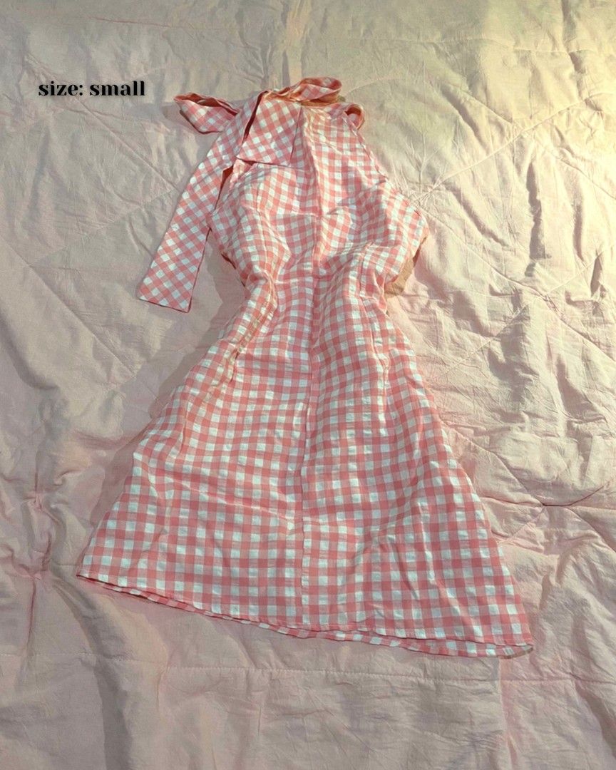 Pink White Gingham Halter Neck Dress (Category: Dresses) located in Santa Cruz. Submitted by gelpcz (Listing ID 1468950399, Image 1). Description: - Style: Halter neck sleeveless mini dress - Pattern: Pink and white gingham - Features: Adjustable tie-back strap - Material: Lightweight and breathable fabric for warm weather - Size: Small.