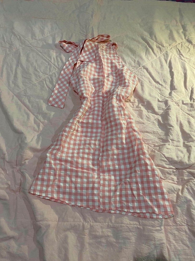 Pink White Gingham Halter Neck Dress (Category: Dresses) located in Santa Cruz. Submitted by gelpcz (Listing ID 1468950399, Image 3). Description: - Style: Halter neck sleeveless mini dress - Pattern: Pink and white gingham - Features: Adjustable tie-back strap - Material: Lightweight and breathable fabric for warm weather - Size: Small.