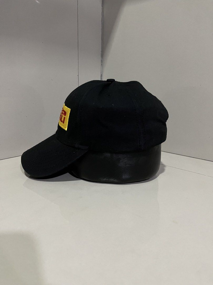 Pirelli Black Baseball Cap (Category: Caps & Hats) located in Maasin. Submitted by niconii090 (Listing ID 1468984705, Image 2). Description: - Brand: Pirelli - Color: Classic black with yellow and red embroidered logo patch - Design: Structured front panels with a curved brim - Fit: Adjustable strap closure at the back, one size fits most - Condition: Clean fabric, ready to wear .