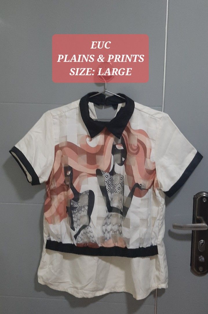 Plains & Prints Graphic Print Collared Blouse (Category: Blouses) located in Manila. Submitted by gleeshoppe_lee (Listing ID 1469048730, Image 1). Description: - Brand: Plains & Prints - Size: Large - Color/Design: White with striking abstract graphic print - Details: Contrasting black collar, sleeve cuffs, and hem band, front button-up closure - Material: Lightweight and comfortable fabric - Condition: Excellent pre-loved condition - Styling: Pe